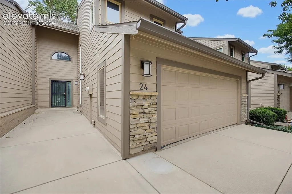 Front exterior of the townhome with stone accents and an attached two-car garage