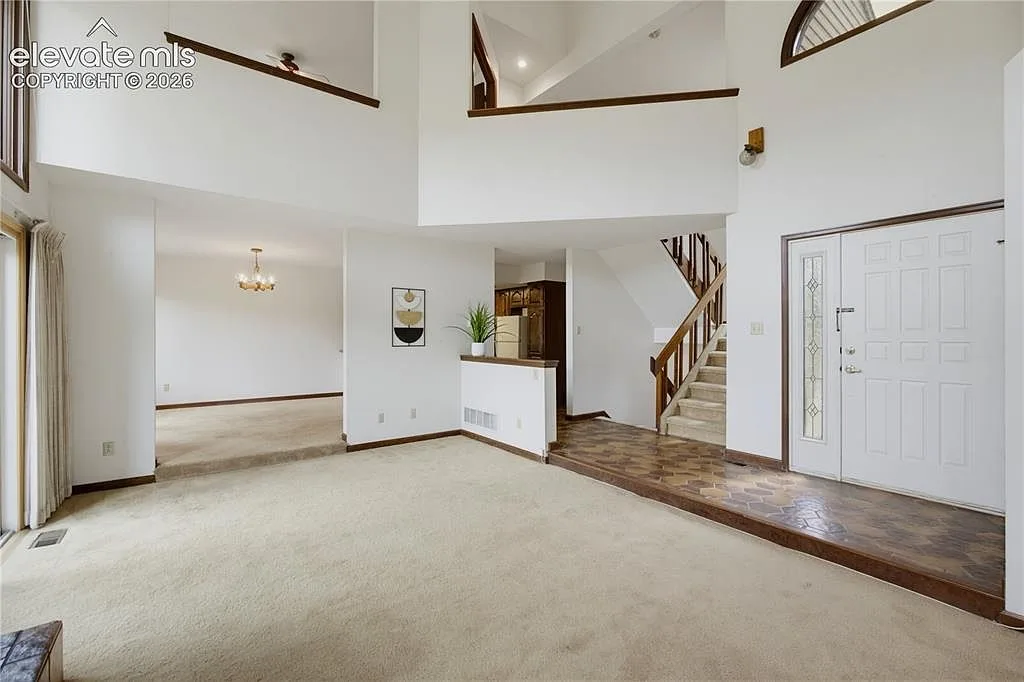 Two-story vaulted ceiling with a loft overlook