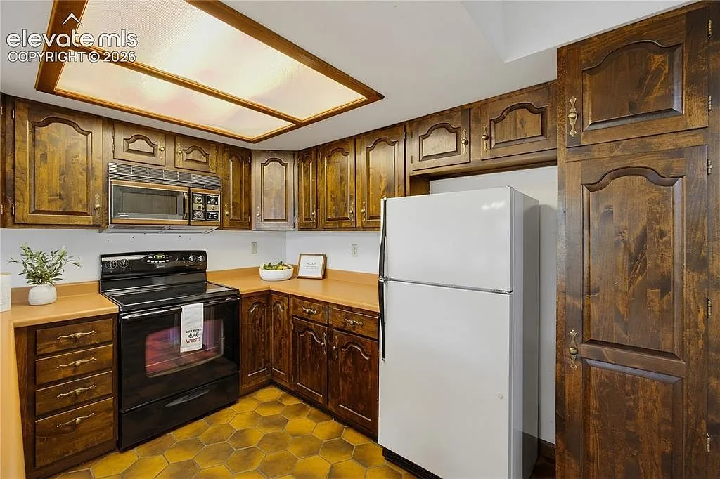 Kitchen with stained wood cabinetry and a breakfast bar