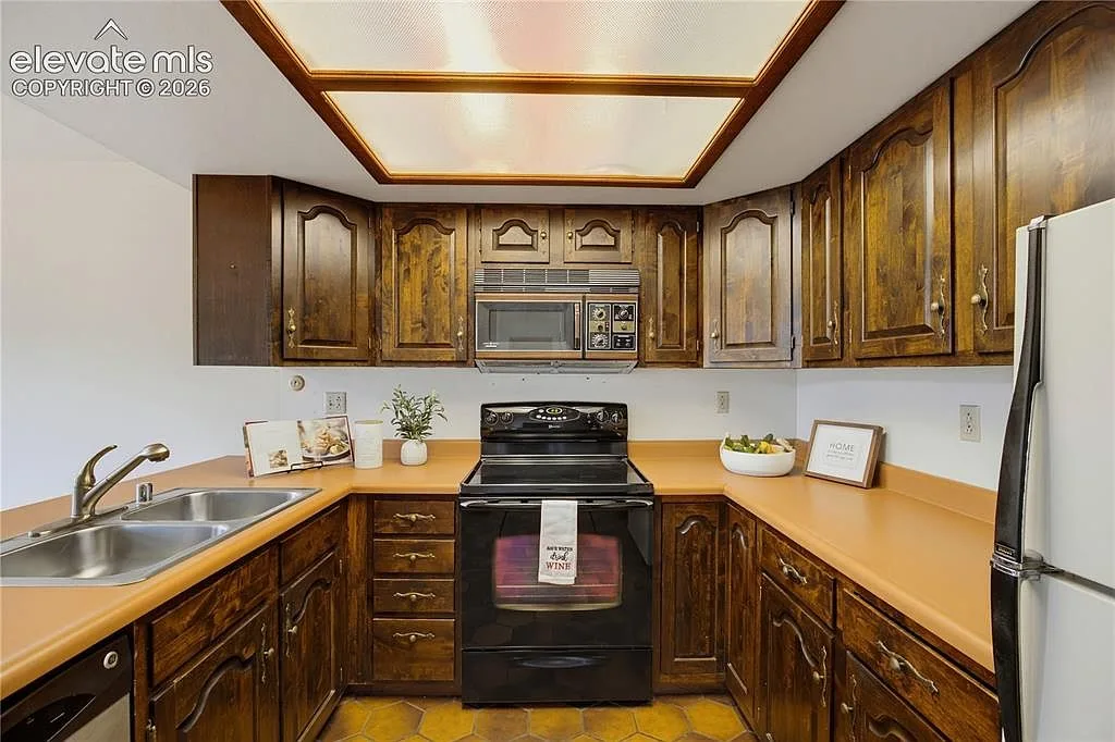 Kitchen with solid-surface countertops and breakfast bar