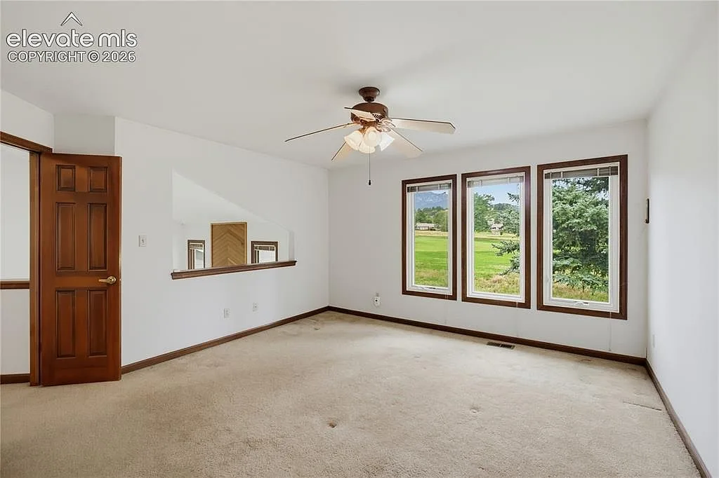 Guest bedroom with wood-trimmed windows