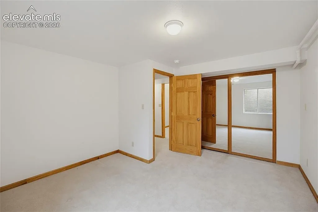 Secondary bedroom with mirrored closet doors