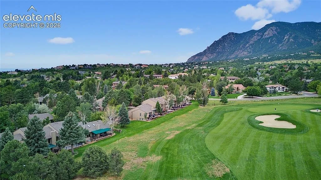 Townhome rooftops beside the golf course and Cheyenne Mountain