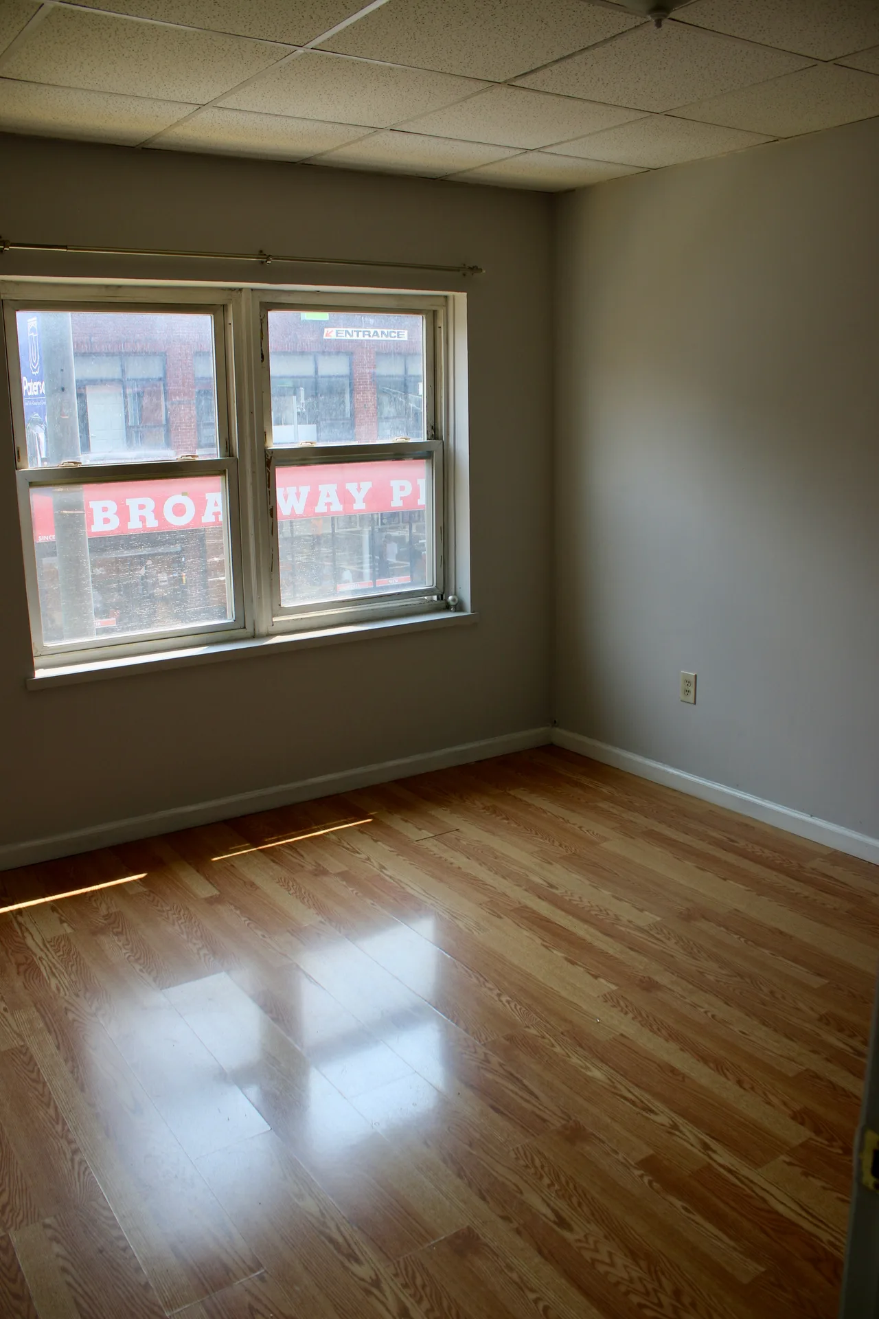 Vacant bedroom with hardwood floors