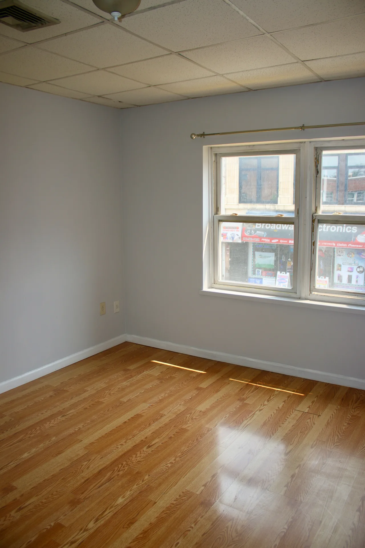 Bright bedroom with hardwood flooring