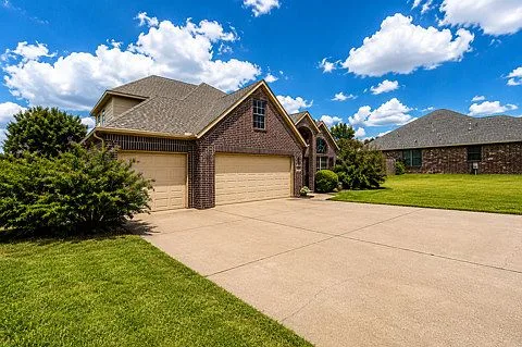 Front elevation with driveway and attached garage at 4604 N Narcissus Ave