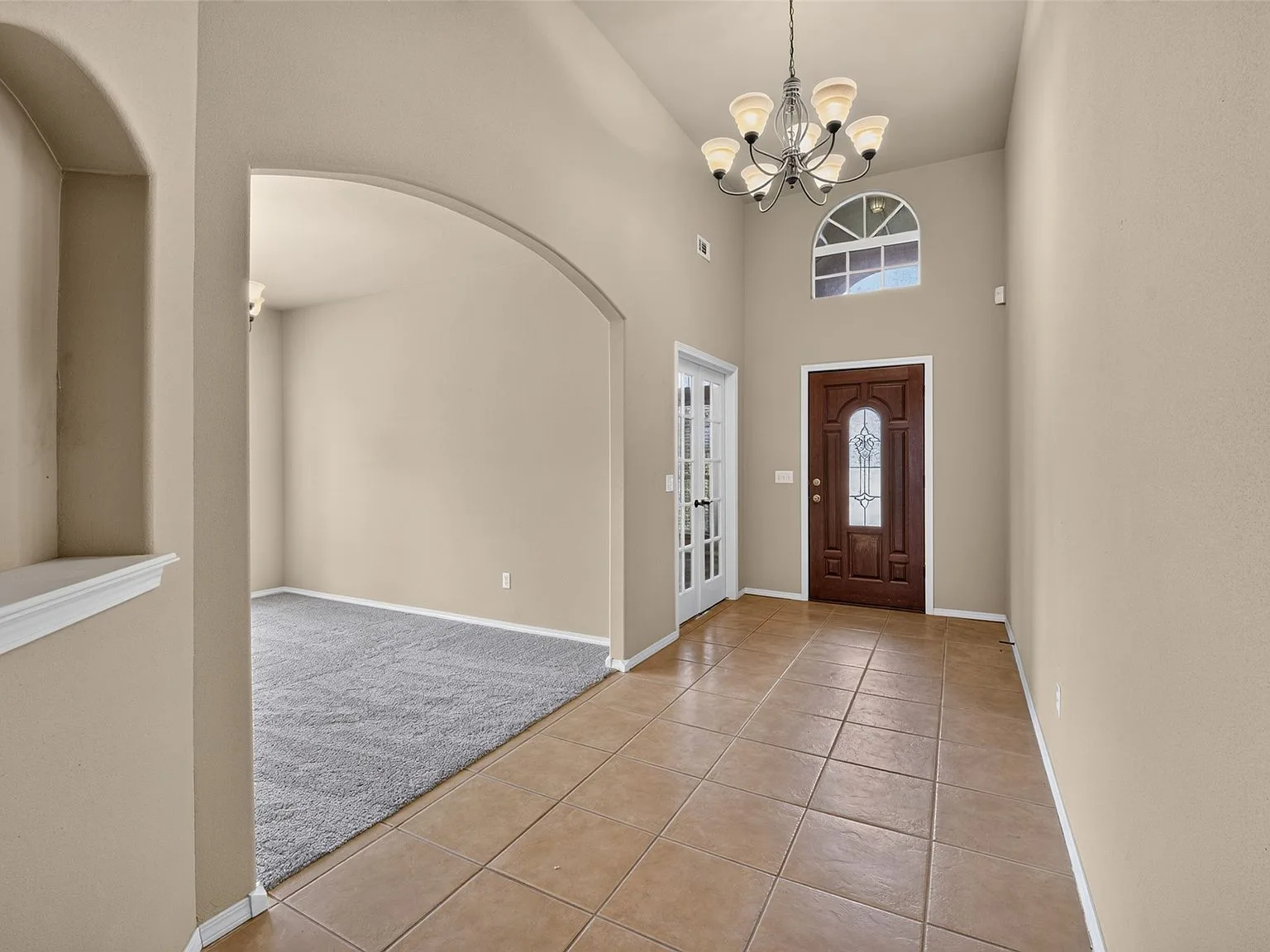 Two-story foyer with archways and tiled entry
