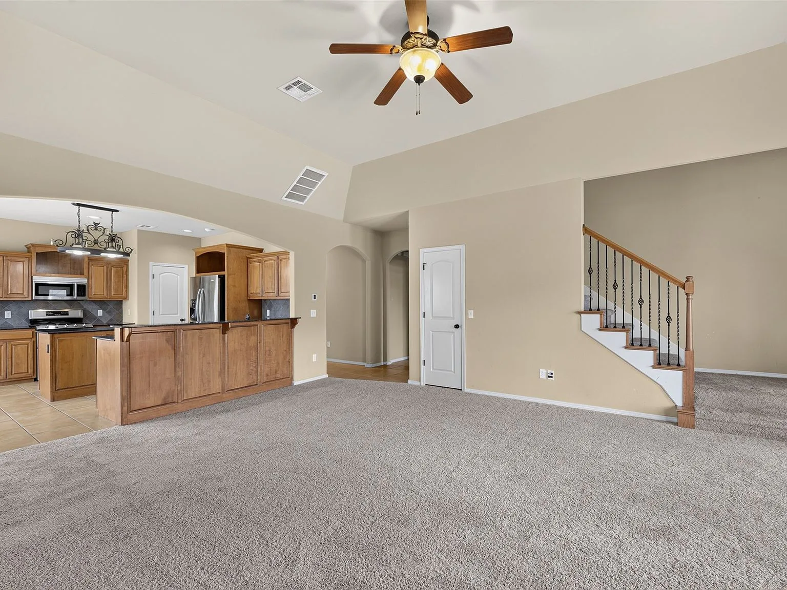 Open living room and kitchen view with vaulted ceiling