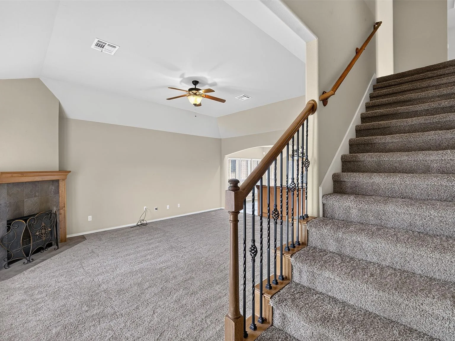 Great room with staircase and stone fireplace