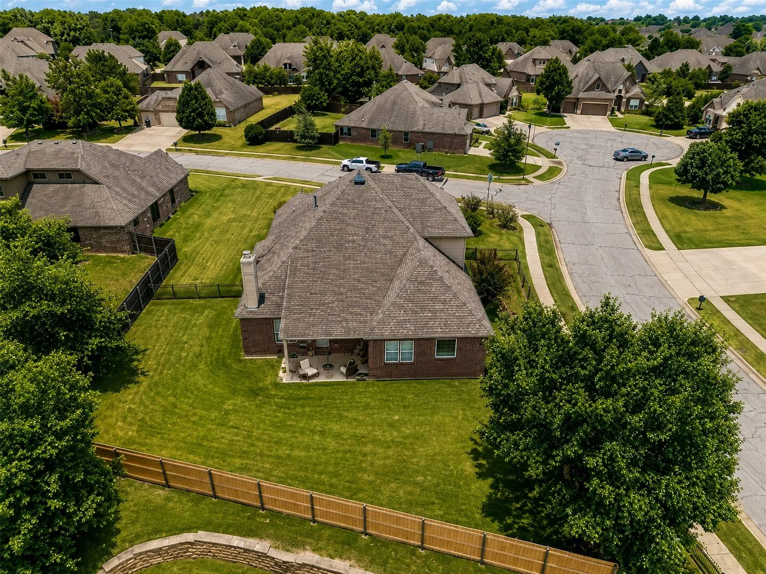 Fenced backyard of 4604 N Narcissus Ave with privacy and split-rail fencing, seen from above
