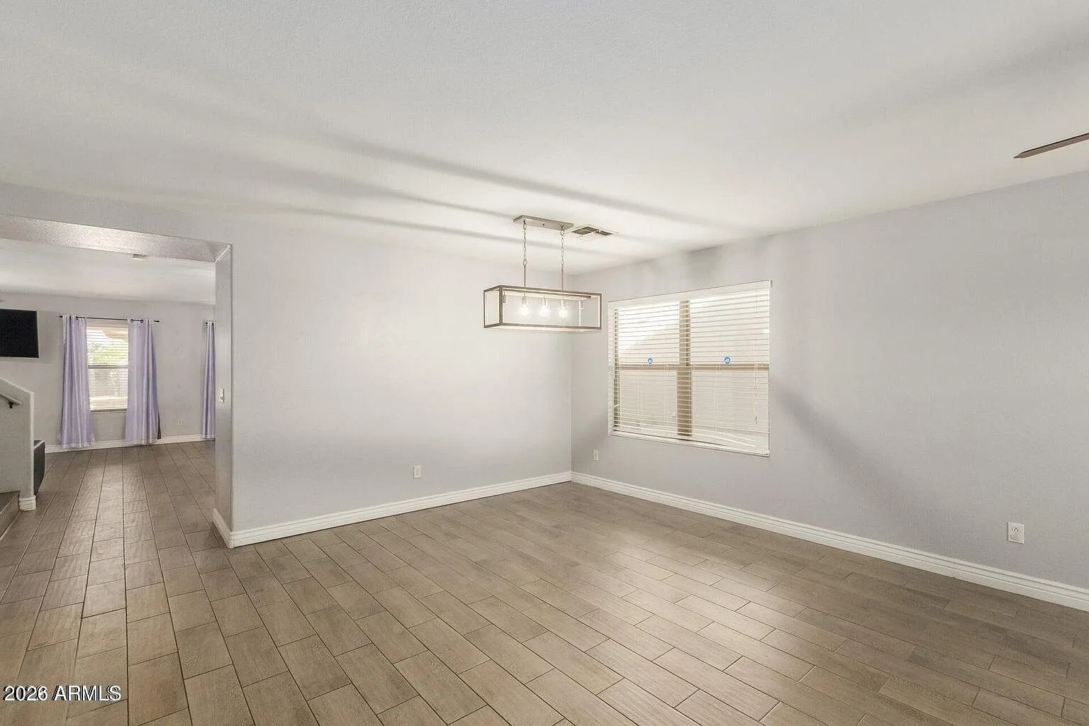 Open concept dining room with wood-look tile floor