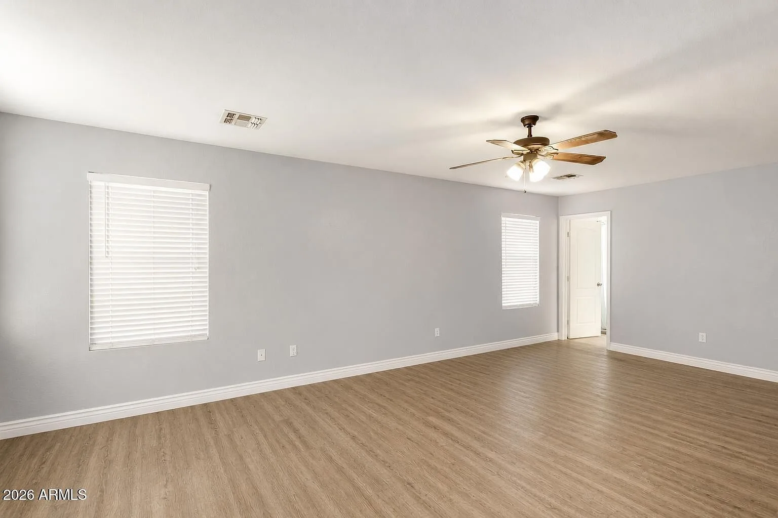 Spacious neutral bedroom with LVT flooring