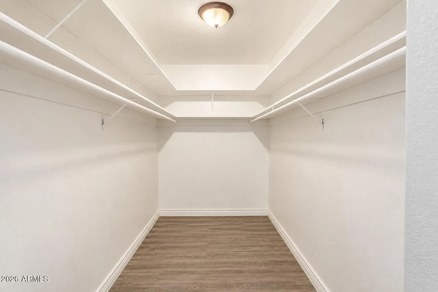 Walk-in closet with white shelving