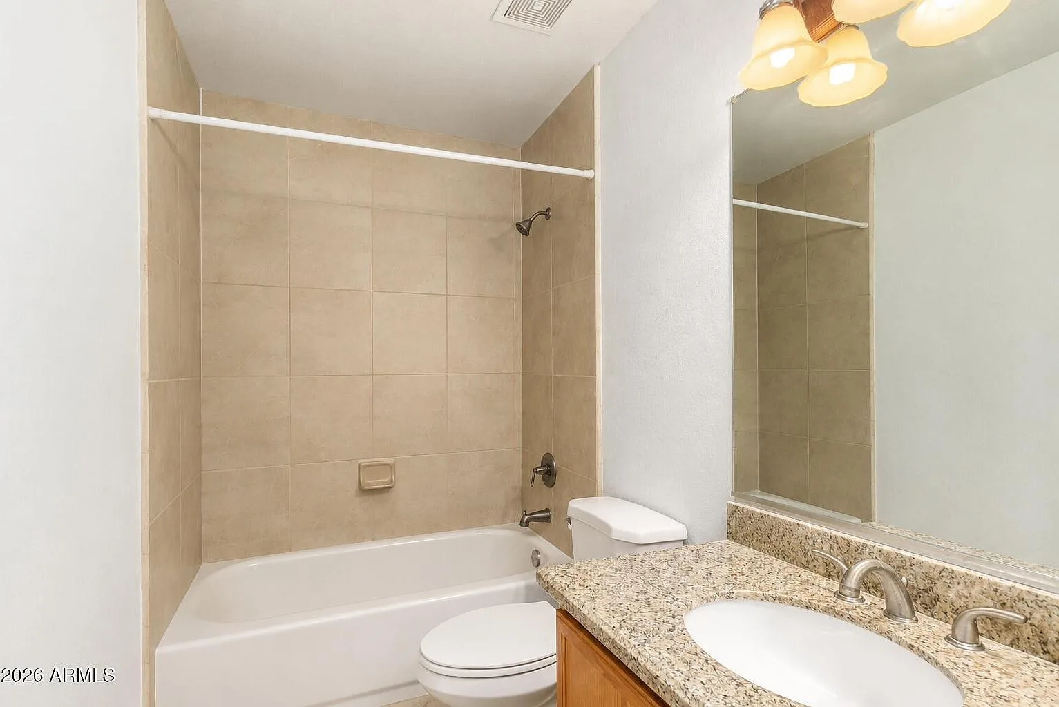 Guest bathroom with wood vanity and granite countertop