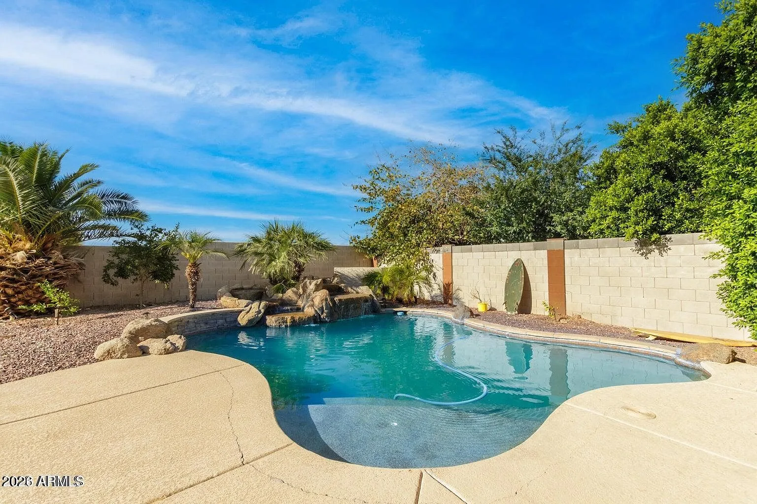 Backyard pool and desert landscaping at 9124 W Elm Street in Phoenix