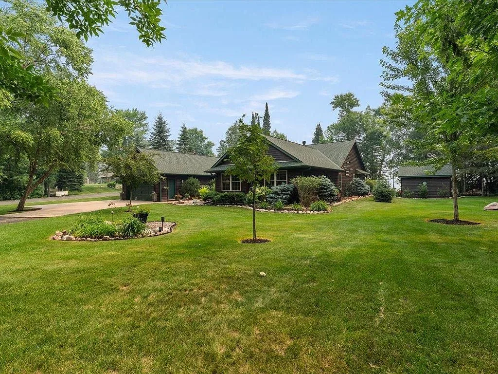 Wide front view with attached garage and detached storage building
