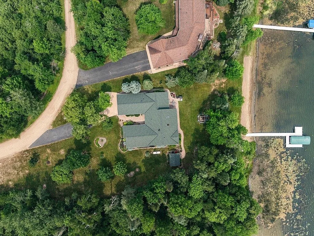 Straight-down aerial of the house, detached shop, firepit, and shoreline