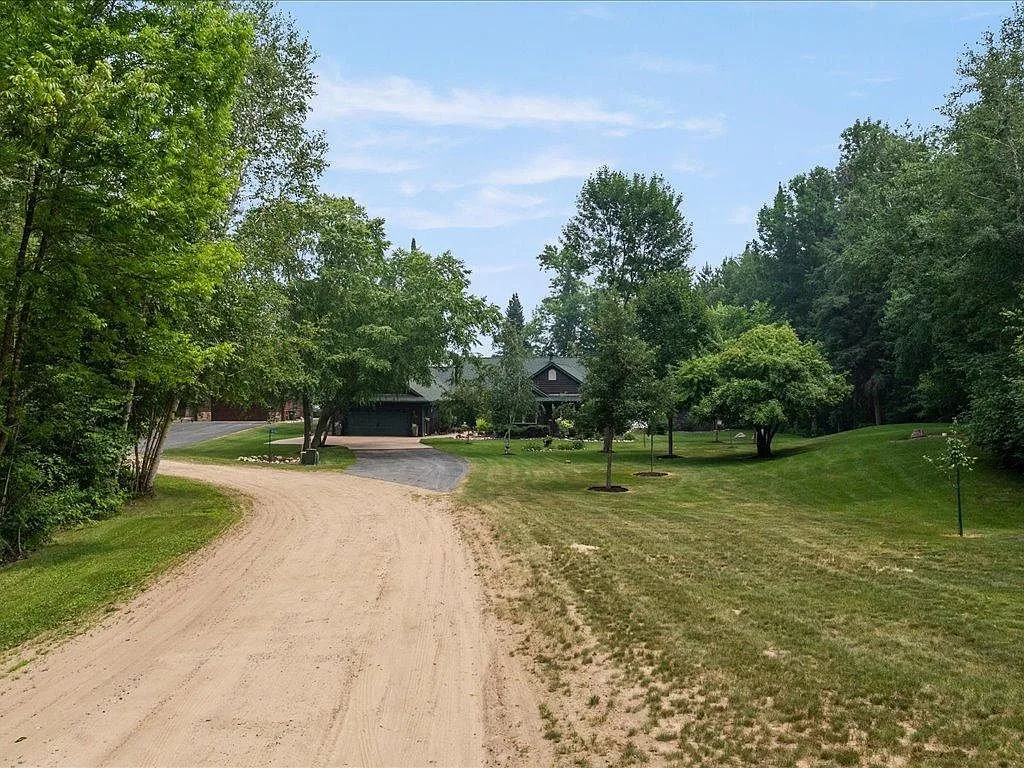Driveway approach through mature trees to the Mitchell Lake home