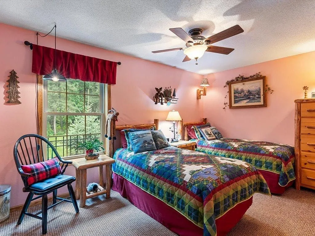 Guest bedroom with twin beds and light wood accents