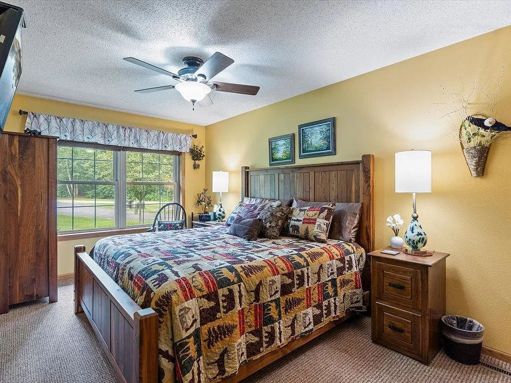 Primary bedroom with rustic wood furniture and warm morning light