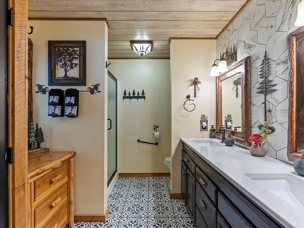 Bathroom with black vanity, white quartz top, and patterned tile