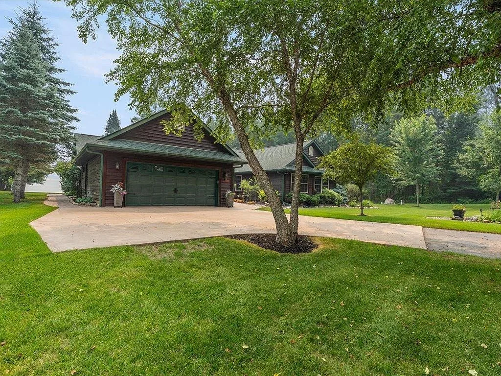 Side facade showing the attached garage and concrete driveway