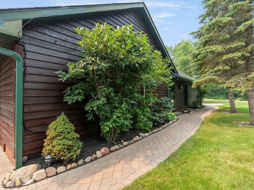 Brick paver side pathway with stone edging and garden beds