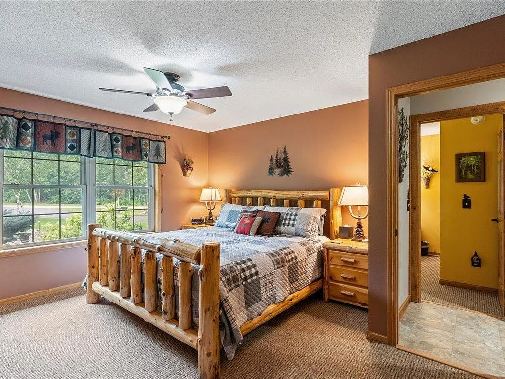 Bedroom with log-style bed frame and natural wood accents