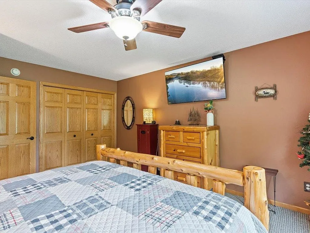 Guest bedroom with log-style bed frame and rustic trim