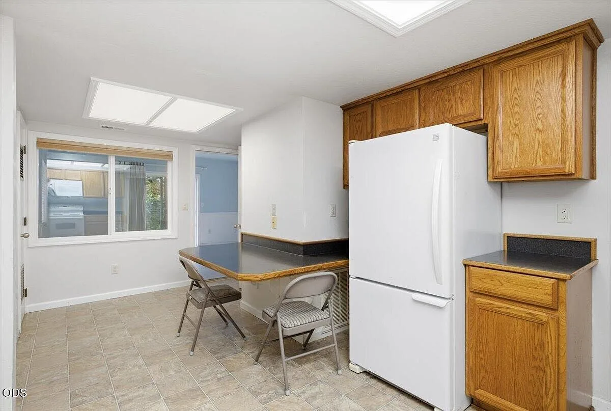 Kitchen breakfast nook with oak cabinetry and daylight from a window