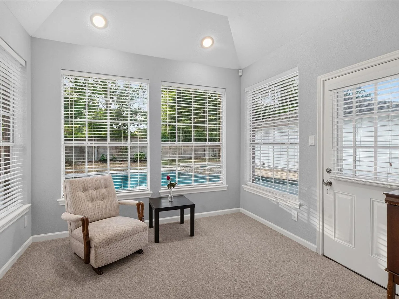 Sitting area off the primary suite with windows overlooking the backyard