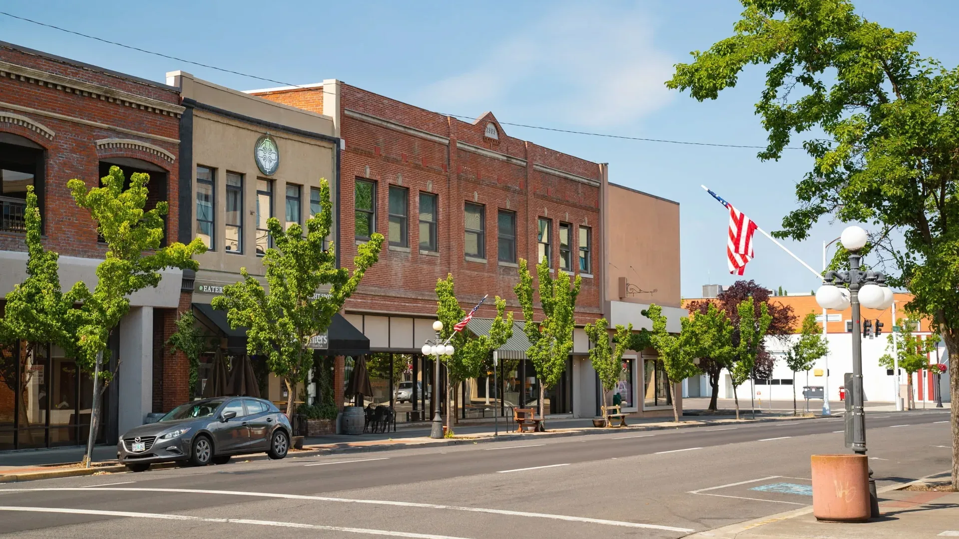 Historic brick Main Street with street lamps and a flag