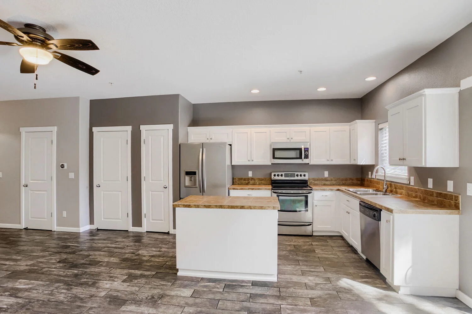 Kitchen with white cabinets at the townhome at 14980 SW Conor Cir, Beaverton, OR