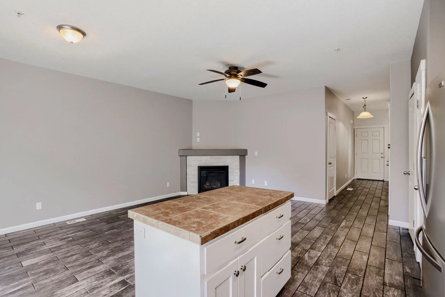 Living area with fireplace and kitchen island at the townhome at 14980 SW Conor Cir, Beaverton, OR