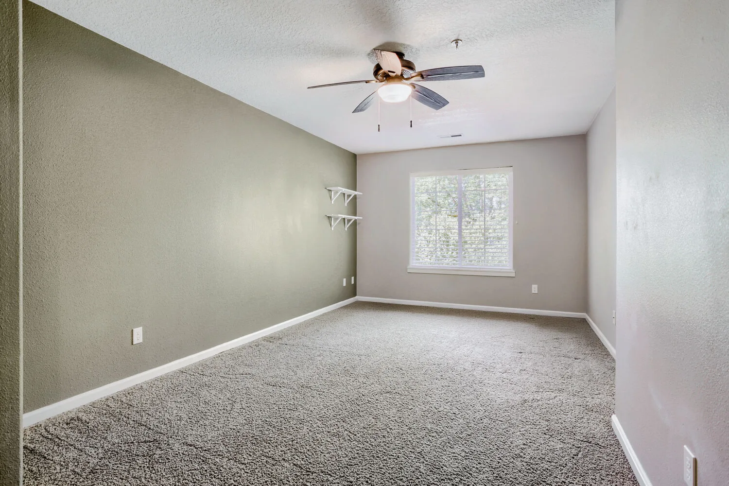 Bedroom with accent wall at the townhome at 14980 SW Conor Cir, Beaverton, OR