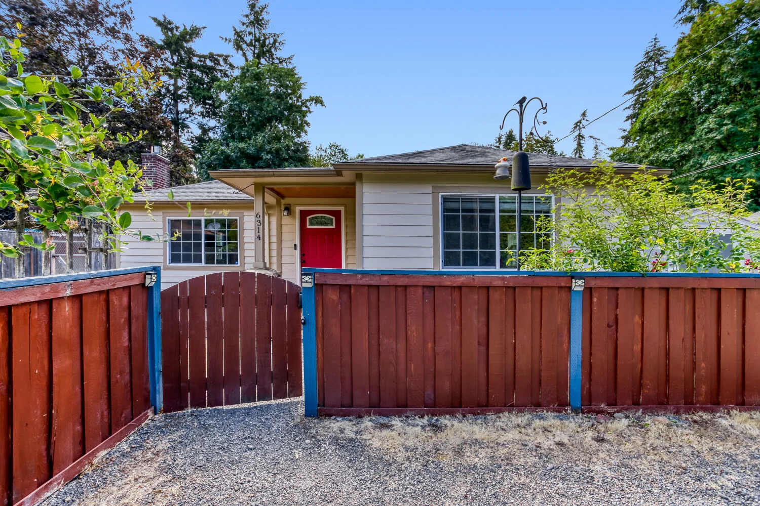 Front facade and wooden gate of the home at 6314 SE Jennings Ave, Milwaukie, OR