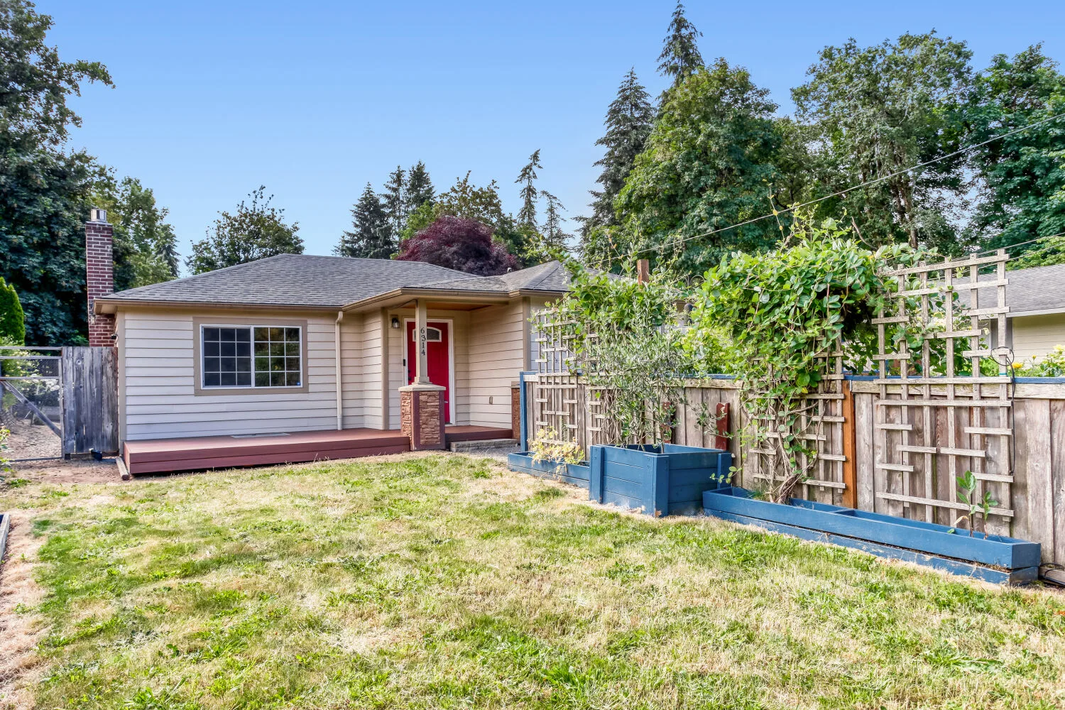 Backyard view of the cottage-style home at 6314 SE Jennings Ave, Milwaukie, OR