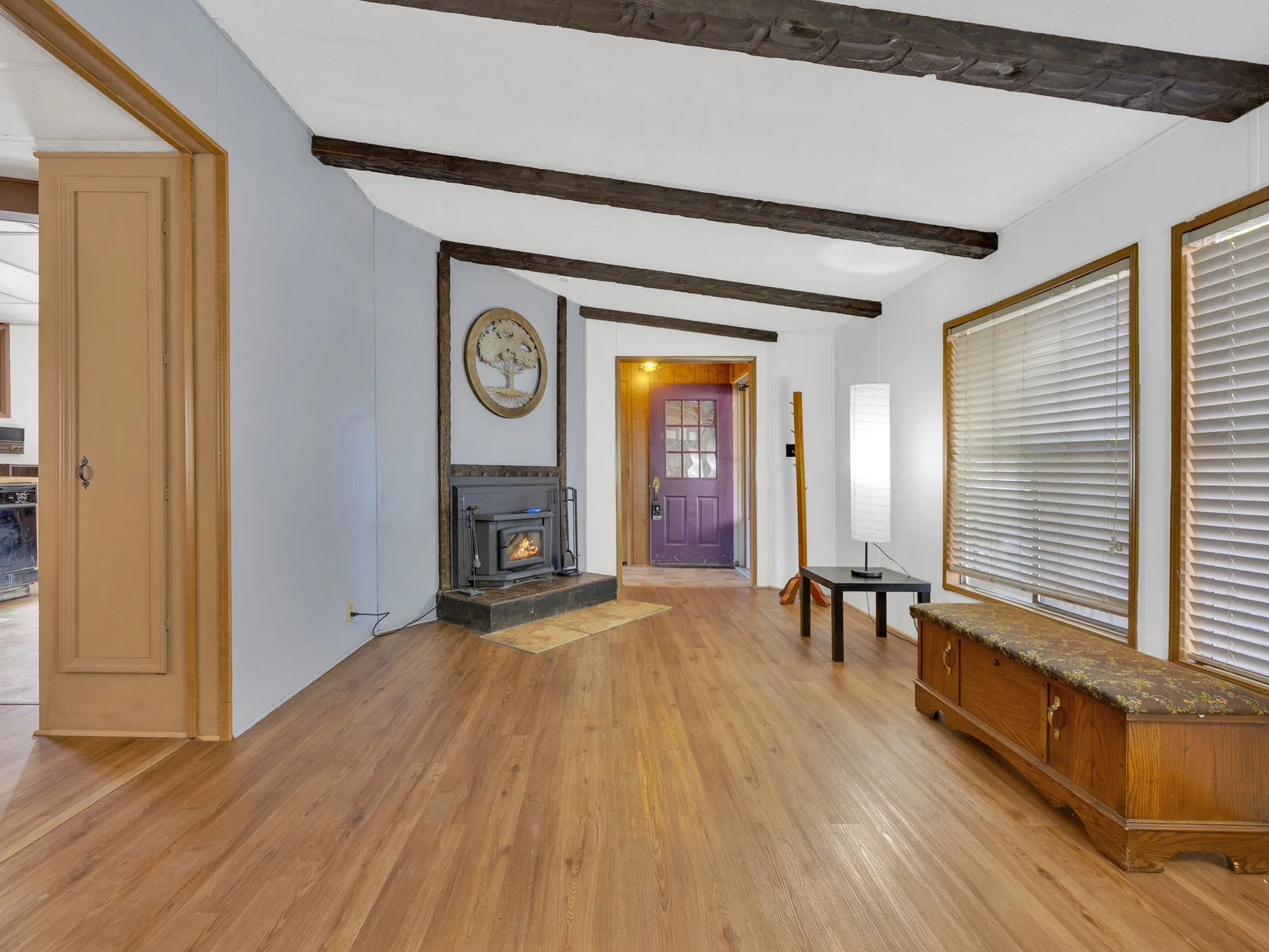 Living room with fireplace and exposed beams at 21100 NE Sandy Blvd #62, Fairview, OR