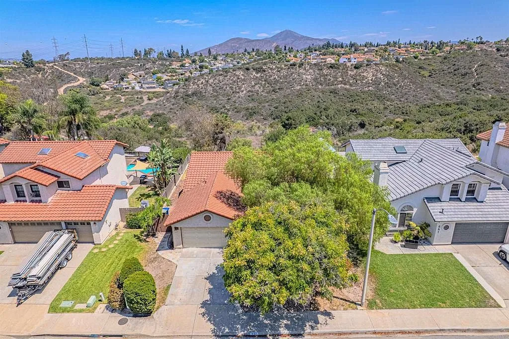 Aerial view of 637 Redlands Pl and the open canyon land directly behind it