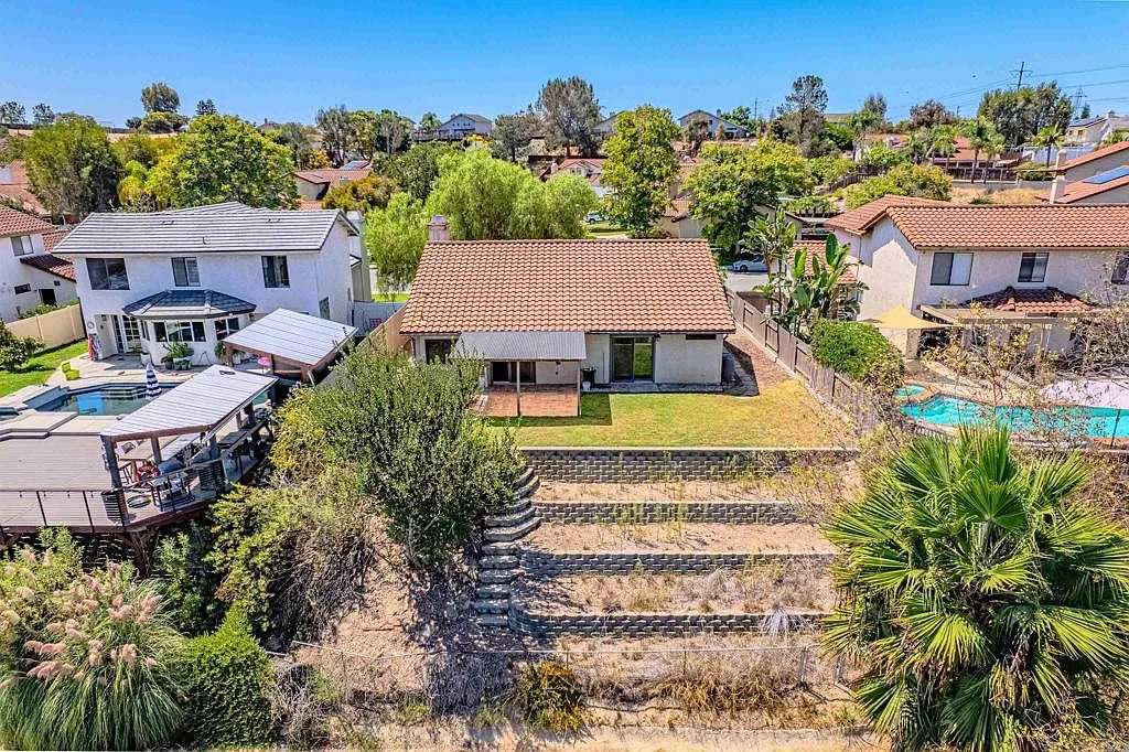 Aerial view of the terraced backyard with stone retaining walls