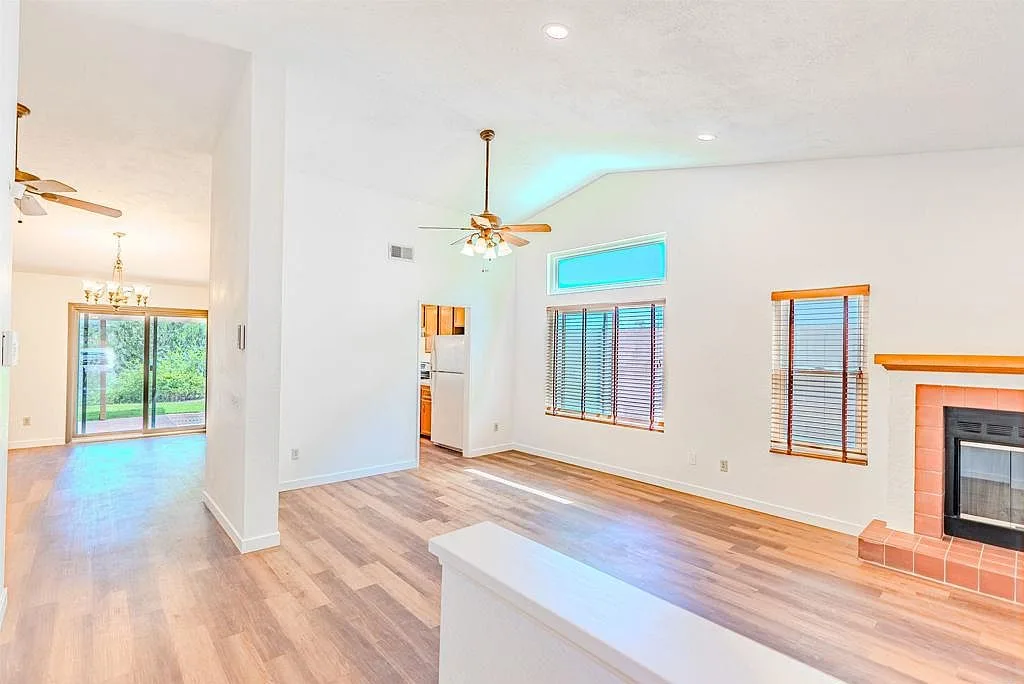 Wide living and dining room with vaulted ceiling