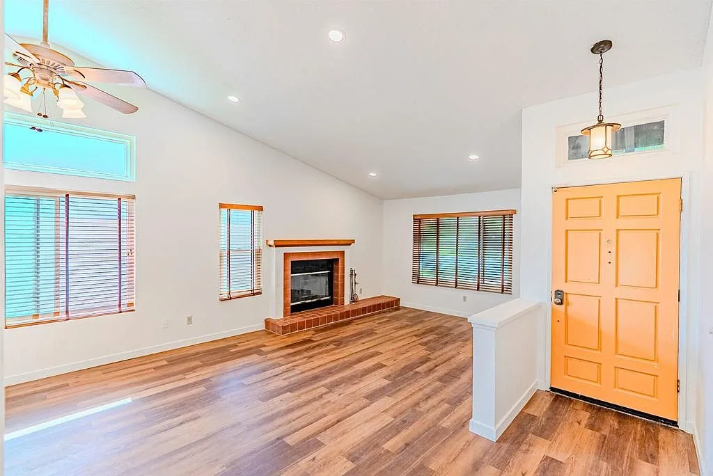 Living room looking toward the entryway with orange front door