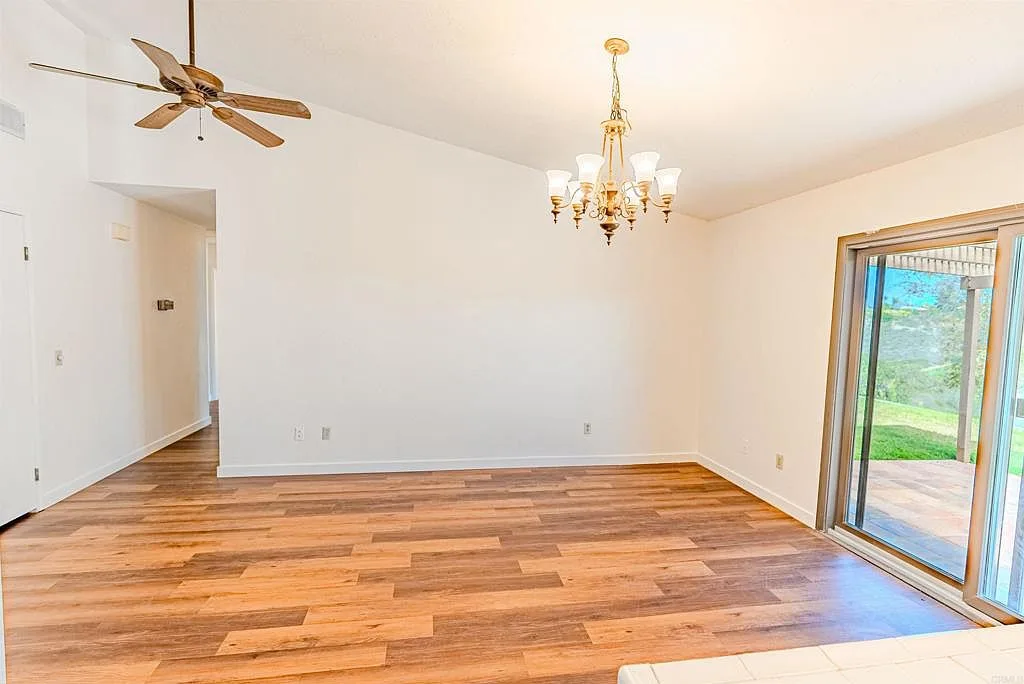 Dining area with vaulted ceiling beside the sliding door