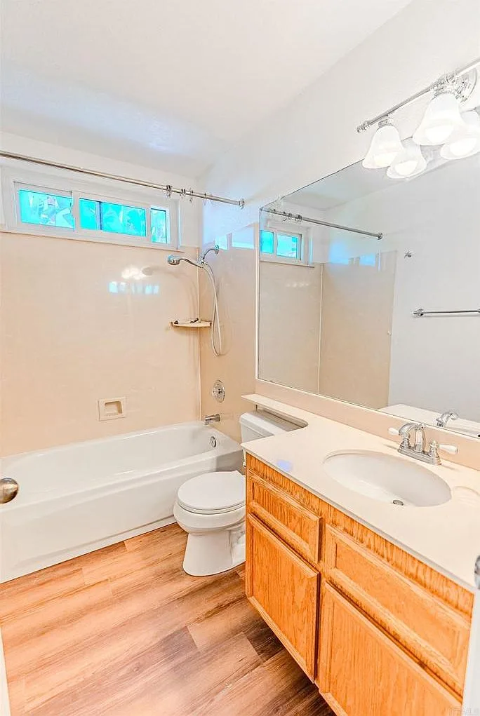 Renovated bathroom vanity with light wood cabinet