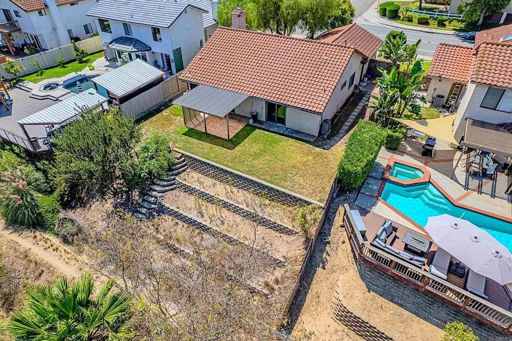Aerial view of the rear of the home and its covered patio