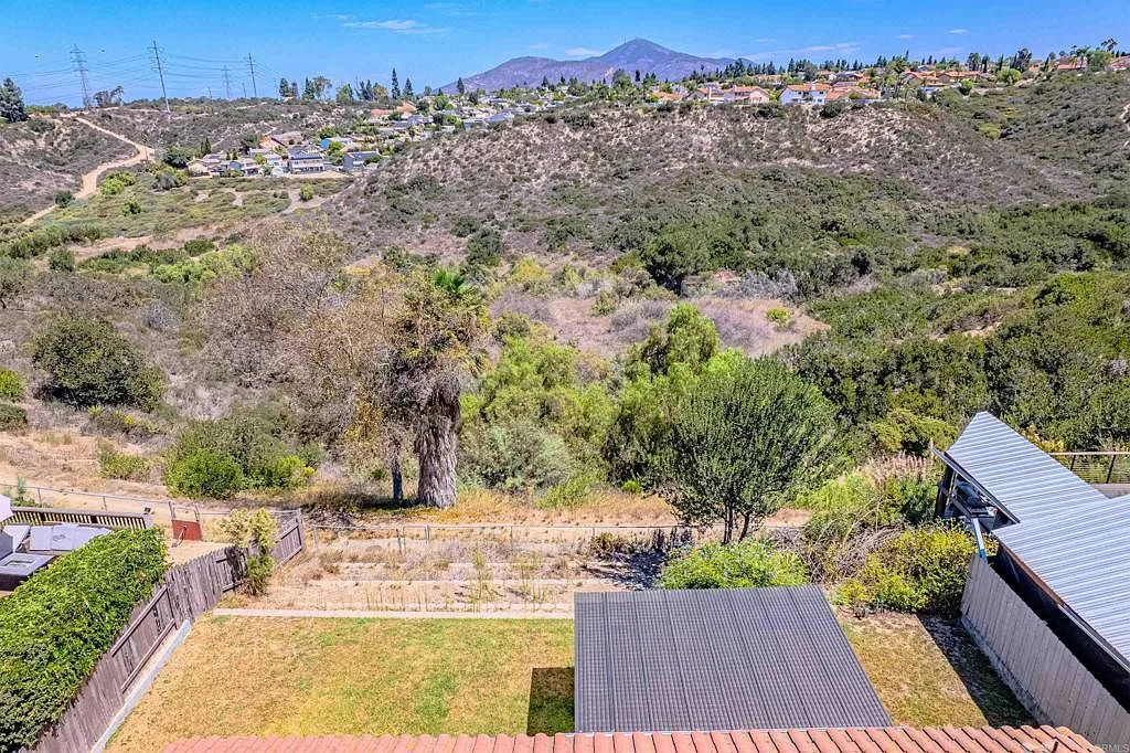 Elevated canyon view with tiered garden beds and wood fencing