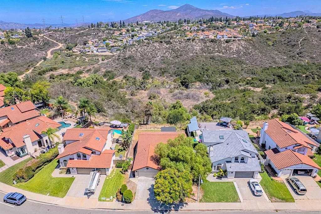Drone view of the neighborhood with canyon open space behind