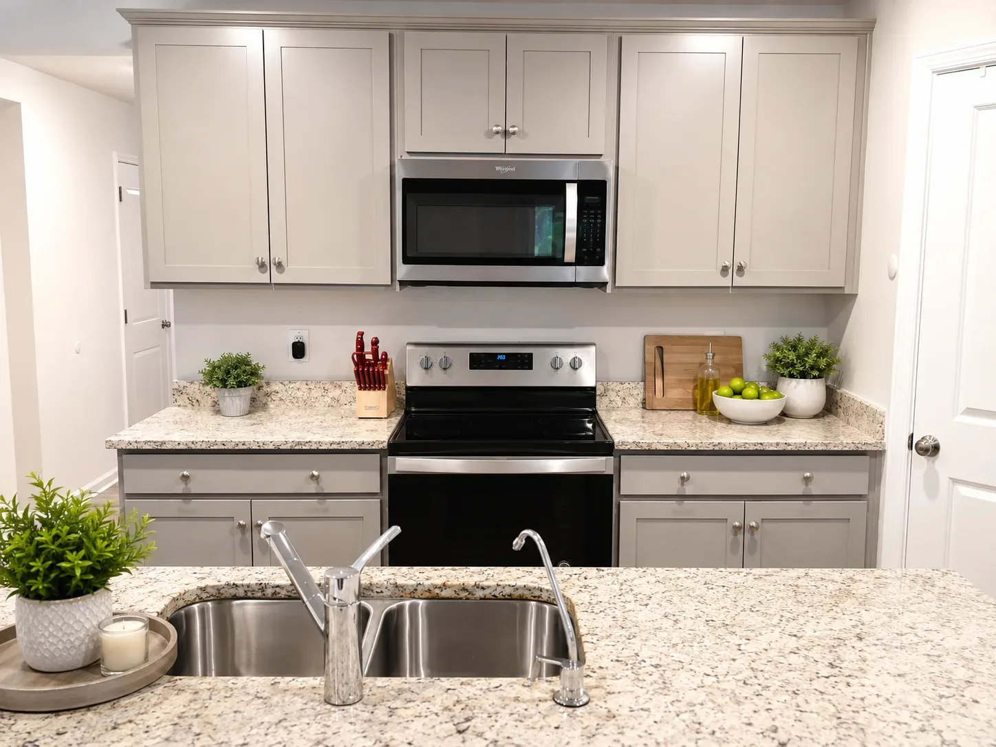 Kitchen with gray shaker cabinets and stainless steel appliances in Ruther Glen