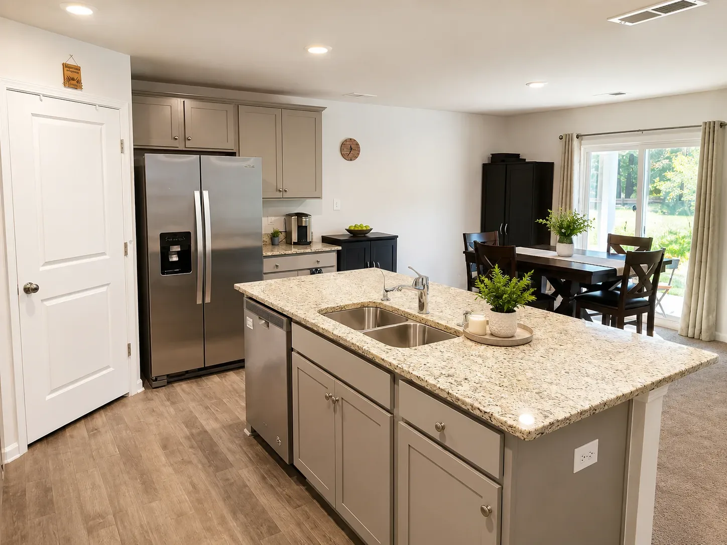 Kitchen with oversized island opening to the dining area in Ruther Glen