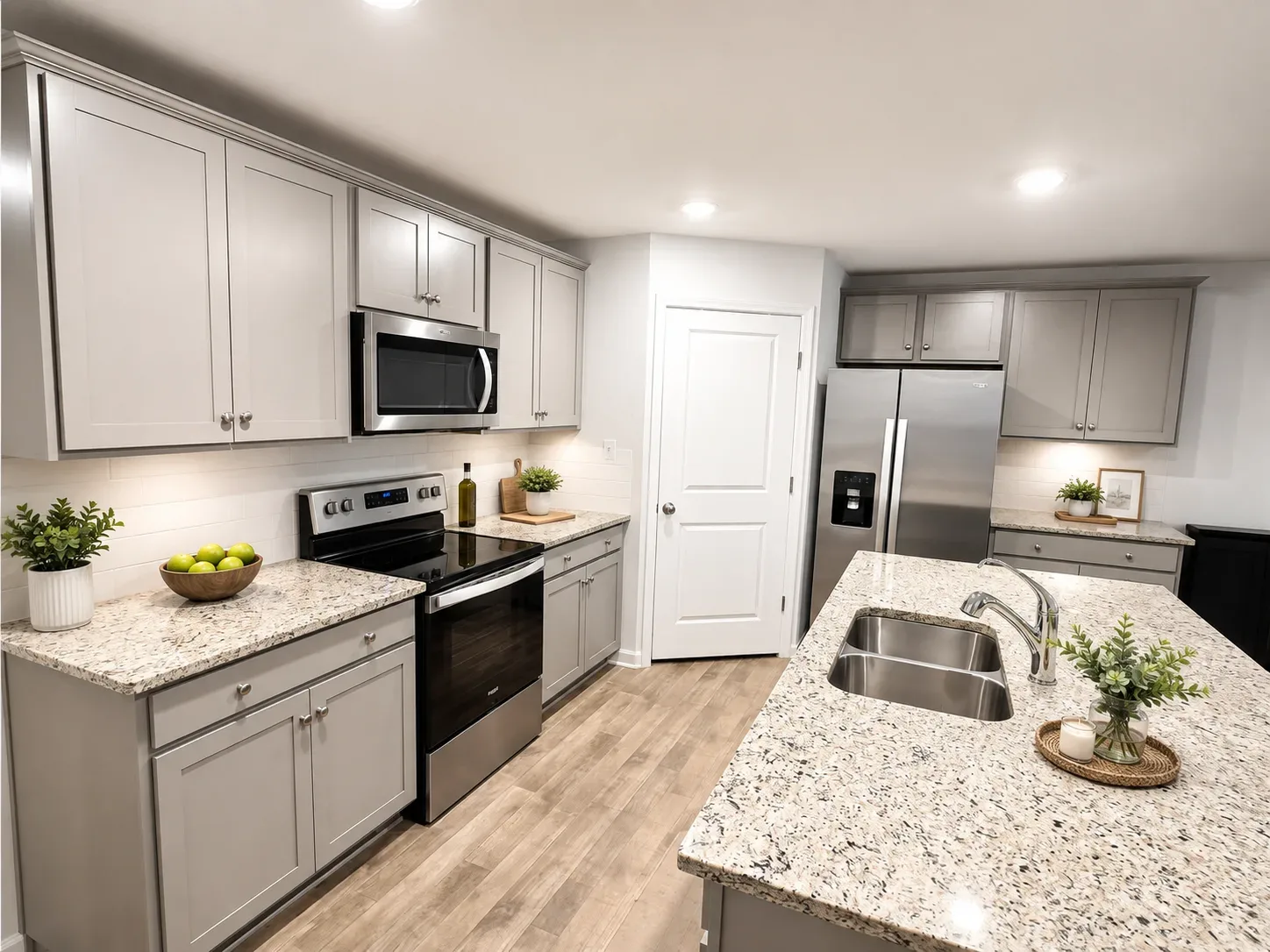 Wide-angle view of the kitchen with granite counters in Ladysmith Village